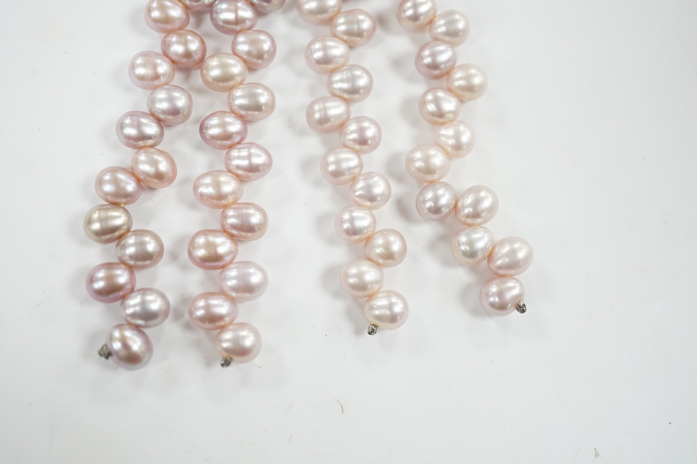 A modern pair of white metal, diamond chip cluster and three row pink cultured pearl tassel drop earrings, 91mm.